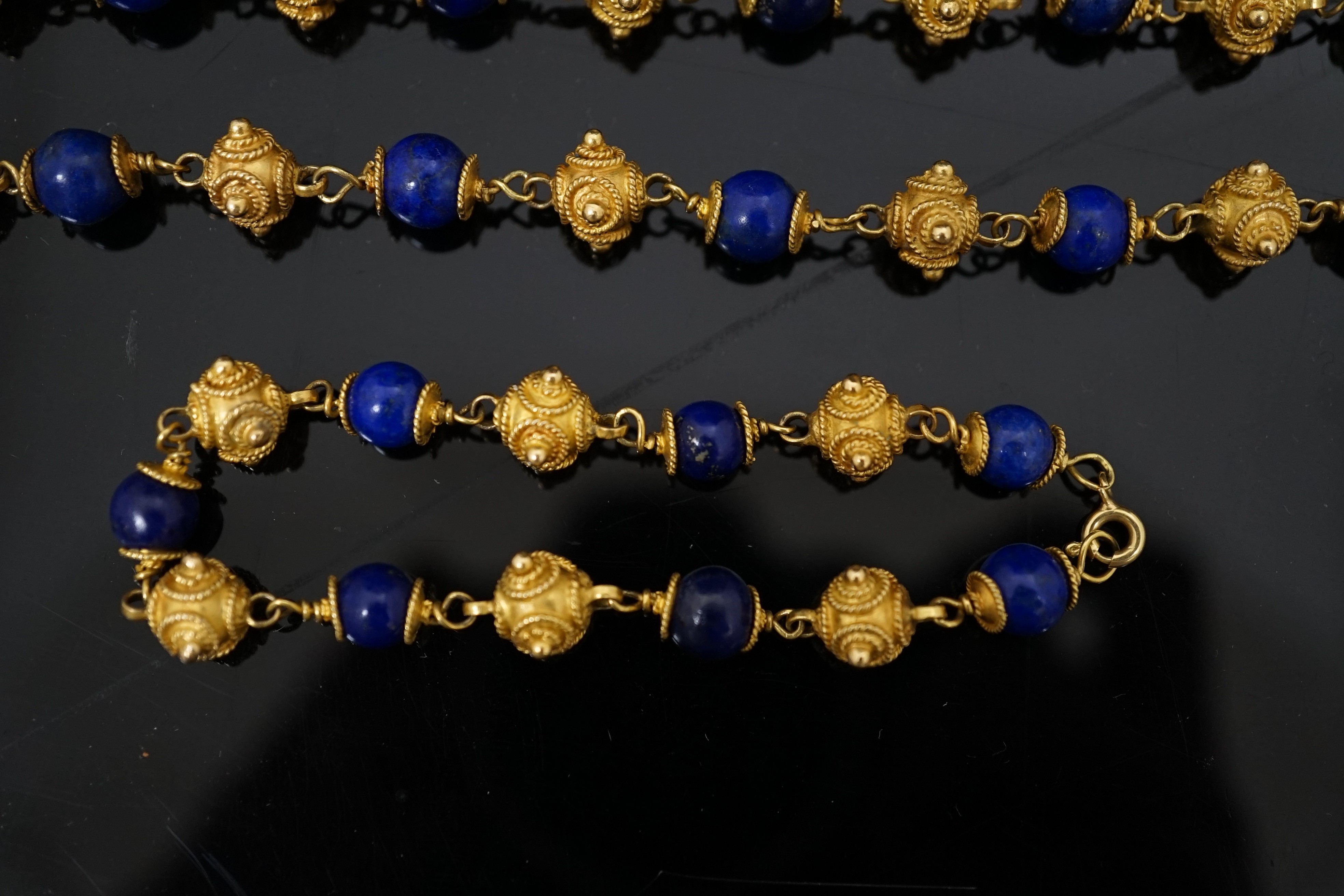 A 20th century Middle Eastern high carat gold canetile work bead and lapis lazuli bead set necklace and matching bracelet